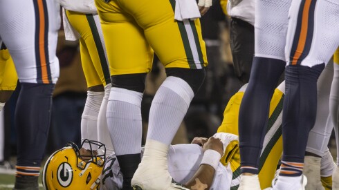 Green Bay Packers quarterback Jordan Love lies on the field after being sacked by Bears defensive end Austin Booker during the second quarter at Soldier Field, Saturday, Dec. 20, 2025.