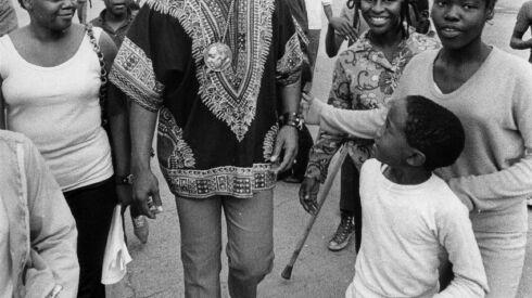 Rev. Jesse Jackson walks with people at the Cabrini-Green Housing Project in July 1970.