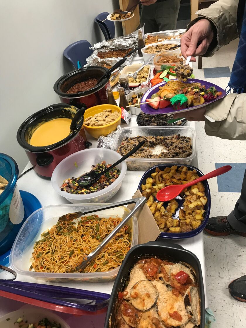 ChicagoVeg members enjoyed more than 20 different dishes for a vegan potluck in Uptown on Dec. 30 and celebrated their ranking as the third friendliest community for vegans and vegetarians worldwide by Meetup. | Taylor Hartz for the Sun-Times.