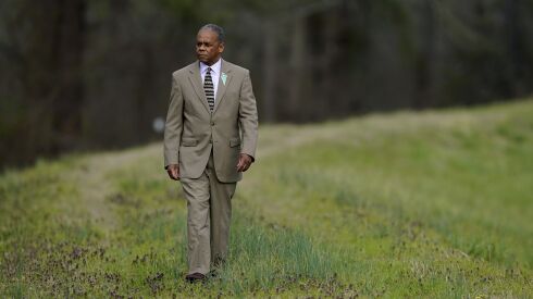Mayor Bobbie Jones looking out over the Tar River from an earthen levee in Princeville, N.C. Jones, a full-time school principal who lives in Princeville and commutes an hour each way to his job in Hertford County, says history compels him and others to work for his town’s survival. “These are sacred grounds,” Jones says. “These are sacred AfricanAmerican grounds.”