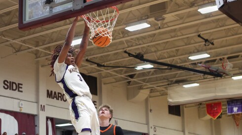 Waukegan's Jaali Rico Love (3) dunks the ball over Hersey's Jake Nawrot (21) during the Elgin Holiday Tournament.
