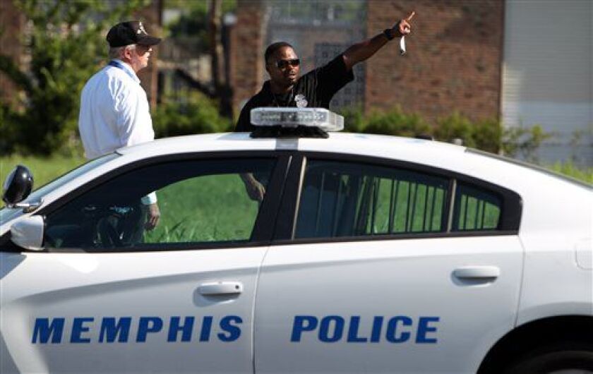 On Sunday, Memphis Police canvas an area near where Police Officer Sean Bolton was fatally shot during a traffic stop Saturday in Memphis, Tennessee. | Mike Brown/The Commercial Appeal via AP
