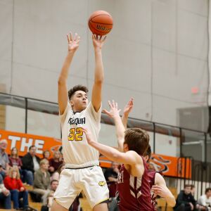 Neuqua Valley’s John Poulakidas (32) shoots the ball over Lockport.