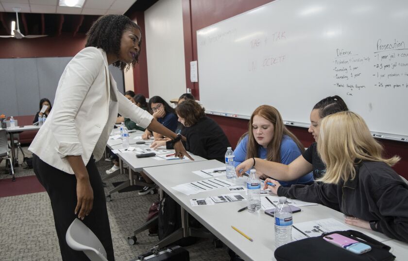 Intelligence Analyst Jorhena Thomas leads Argo Community High School girls through an exercise on disinformation.