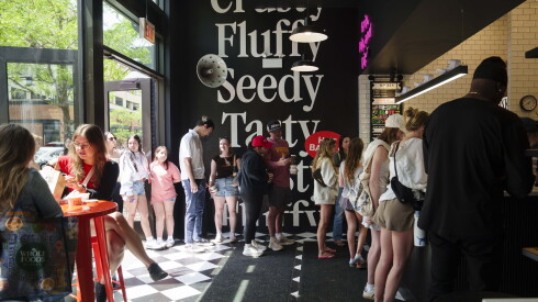 Dozens of customers line up at PopUp Bagels in Lincoln Park, Saturday, May 30, 2026.