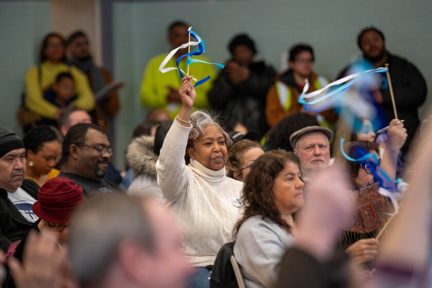A member of the audience waves a ribbon to praise a speaker at the South Chicago Quality of Life Plan at SALUD Center in South Chicago on Saturday, Jan. 31, 2026. | Giacomo Cain/Sun-Times T