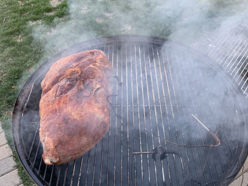 Place the pork shoulder in your smoker. Add several chunks of wood to the coals. I use hickory, cherry or apple.