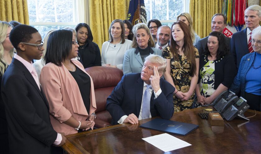 Yvonne Ambrose of Chicago talks to President Donald Trump before he signed a bill intended to curb sex trafficking. Ambrose’s daughter, Desiree Robinson, was killed after a pimp offered her up on Backpage.com., a website that has been criticized for inclu