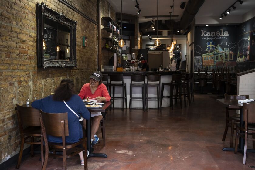 Caryn Garaygay, left, and Pacita Castillo-Reiter eat at Kanela Breakfast Club at 5413 N. Clark St. in Andersonville, Wednesday morning, June 3, 2020.