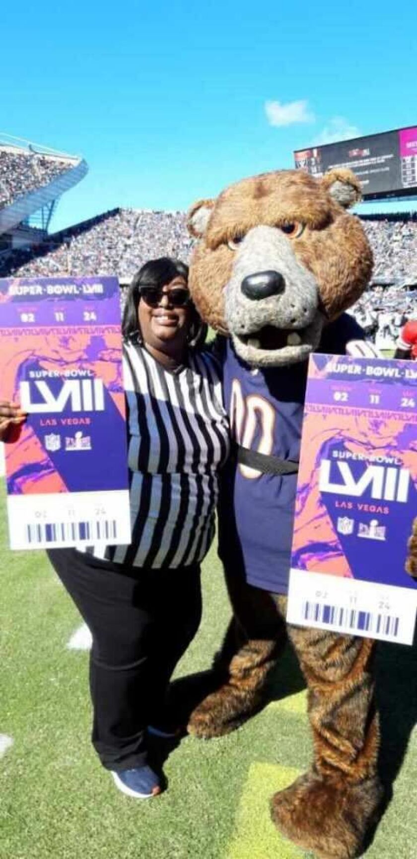 Shameka Leach and Chicago Bears mascot Staley Da Bear pose after Leach found out she was the 2023 Bears Fan of the Year Oct. 22 at Soldier Field.
