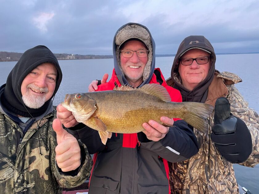 Kevin Tabor and Bill Gros with a Big Green smallmouth bass, held by Mike Zindrick. Provided by Mike Norris