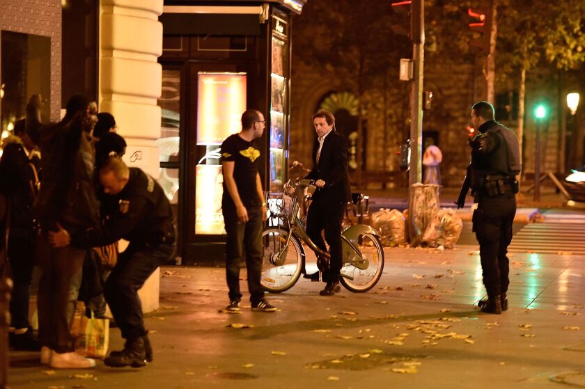 Military police officers check pedestrians on Friday in Paris, after a series of attacks across the French capital. Early casualty reports indicated at least 118 people had been killed. | Pascal Le Segretain/Getty Images