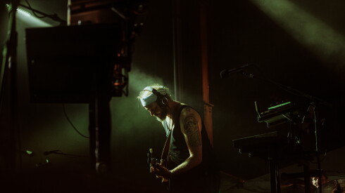 Bon Iver, aka Justin Vernon, plays guitar during a performance.