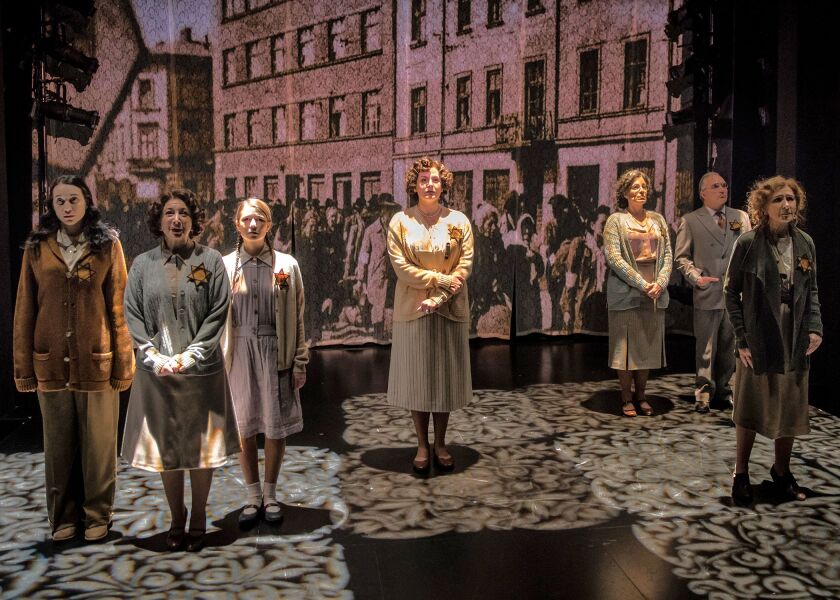 The cast of the Chicago Shakespeare Theater production of “The Book of Joseph,” seen against archival footage from occupied Poland in World War II. (Photo: Liz Lauren)