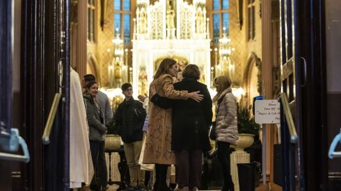 Students and their supporters hug as they walk out of Church of the Holy Family after a special mass for 16 student hockey players from St. Ignatius College Prep that were injured in a bus accident, Monday evening, Nov. 14, 2022. Saturday evening, the school’s junior varsity Wolfpack team was on a bus in Warsaw, about 50 miles south of South Bend, Indiana, when a semitruck crashed into the bus. | Ashlee Rezin/Sun-Times