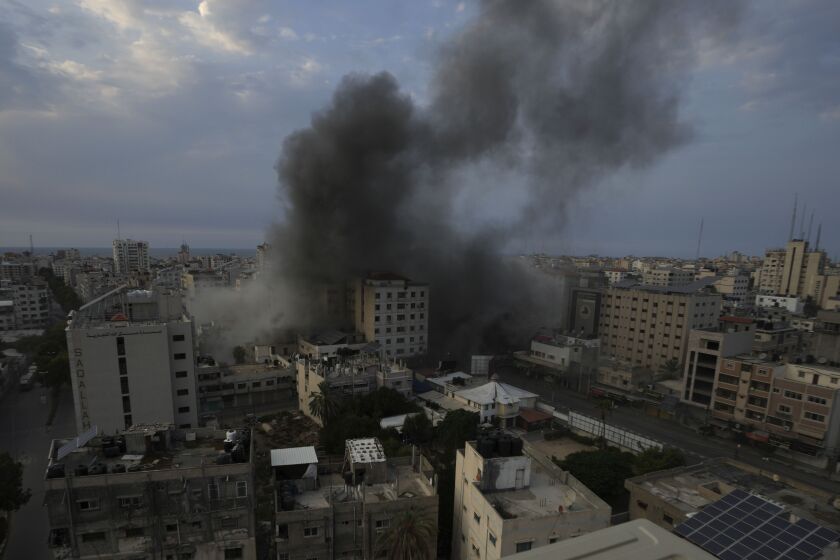 Smoke rises from an explosion on the Islamic National Bank following an Israeli air strike in Gaza City, at Gaza City on Oct. 8, 2023.