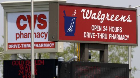 CVS and Walgreens signs on adjacent corners at a Calumet City intersection.