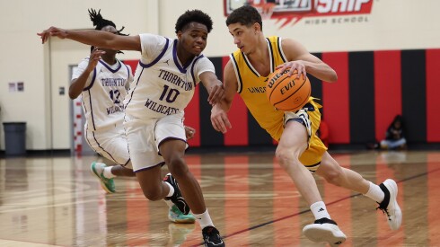 Thornton's Joseph Thomas (10) defends as Lincoln Park's Ahmad Lee drives toward the basket.