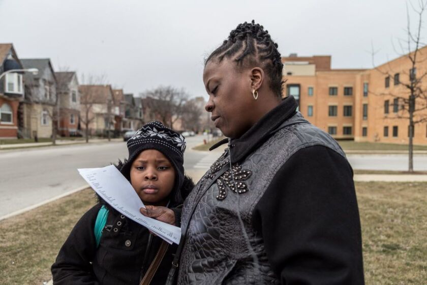 Latoya Spencer and her 9-year-old daughter, Rakiyah Green, react to CPS inspection reports on Jackie Robinson Elementary, where Green is a third-grader. | Erin Brown/Sun-Times