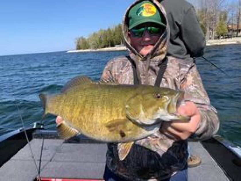 Matt “Man” Arambasich sent this photo of his son John with a good smallmouth from Sturgeon Bay. Provided photo