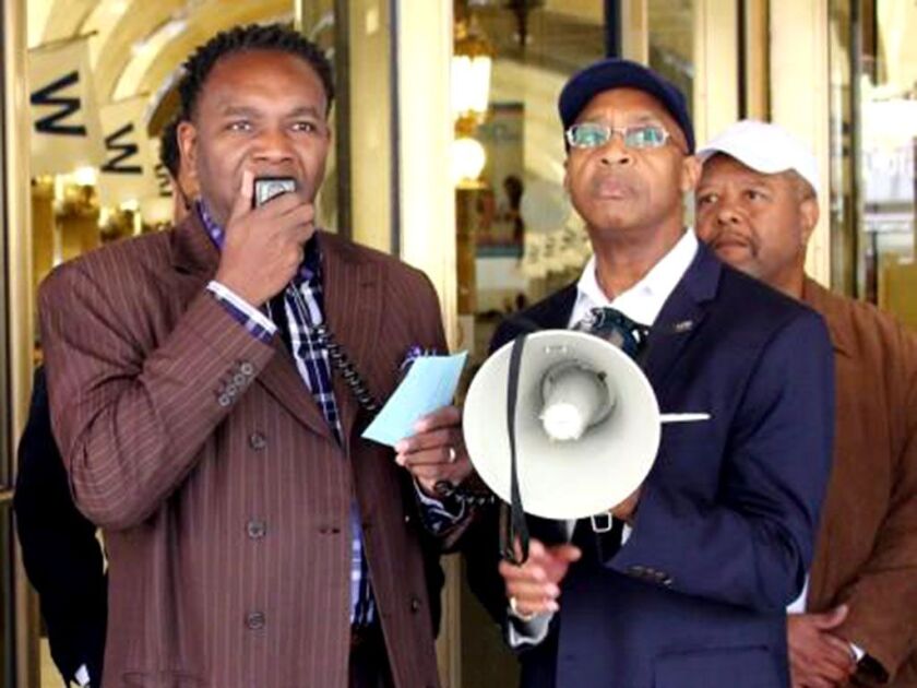 Karl Brinson, right, president of the NAACP West Side Branch, leads an October 2017 protest with the Rev. Ira Acree of Chicago’s Greater St. John Bible Church. The NAACP has filed a lawsuit against the administration’s revocation of TPS for Haiti. | Provi