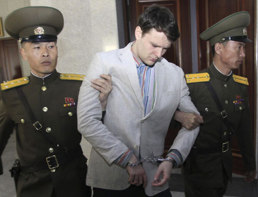 American student Otto Warmbier (center) is escorted at the Supreme Court in Pyongyang, North Korea in March 2016. | Jon Chol Jin/Associated Press