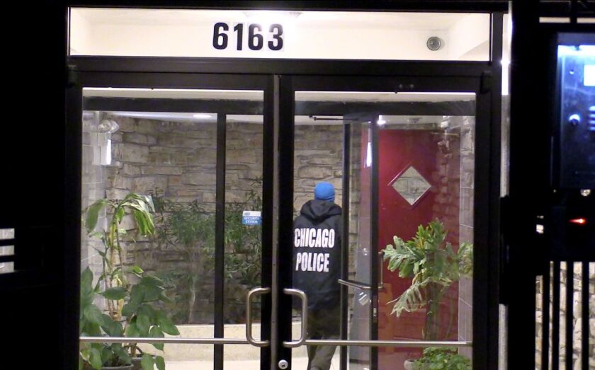 A Chicago Police officer responds to a fire early Saturday in the 6100 block of North Kenmore where a 76-year-old woman was found dead. | Justin Jackson/Sun-Times