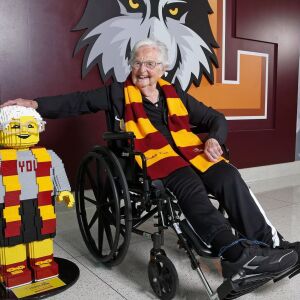 Sister_Jean_hand_on_LEGO_head_for_100th.0.jpg