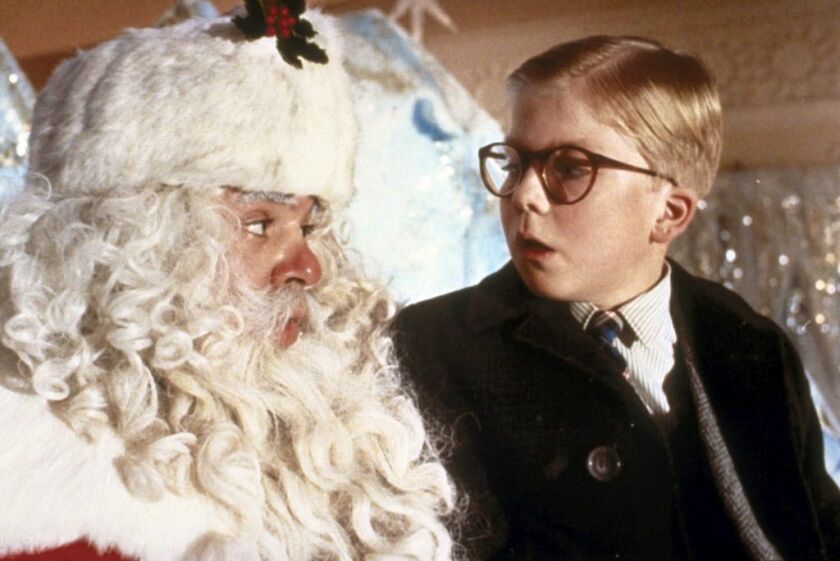 Ralphie (Peter Billingsley, right) gets intimidated on Santa’s lap in “A Christmas Story.”
