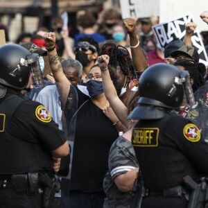 Protesters face off with police outside the Kenosha County Courthouse in the second night of unrest after police shot Jacob Blake, Monday night, Aug. 24, 2020.