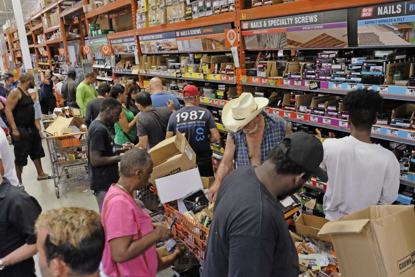 Customers at a Home Depot in South Miami Dade buy building materials to secure their property as they prepare for Hurricane Irma early Friday. | Gaston De Cardenas/Associated Press
