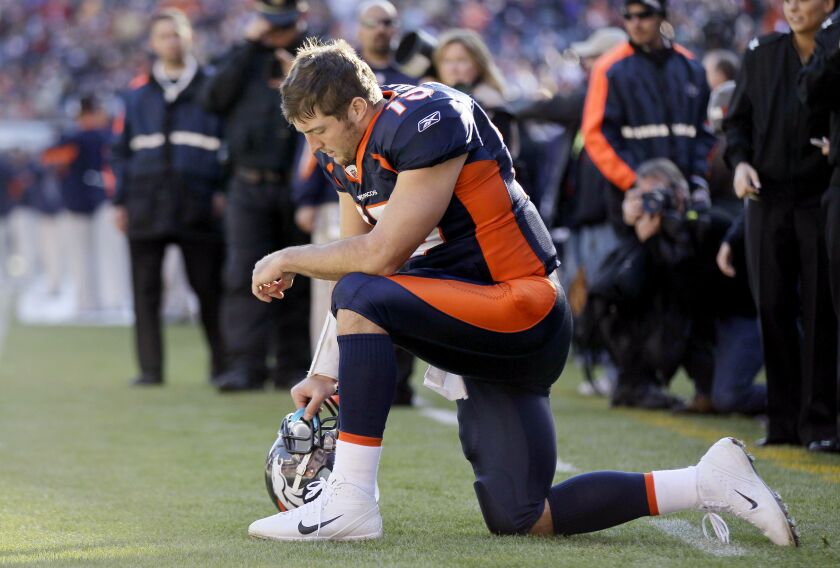 Broncos quarterback Tim Tebow used to kneel before games in prayer. | Julie Jacobson/Associated Press