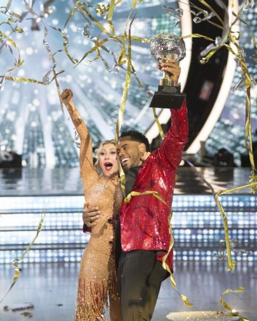 Rashad Jennings and Emma Slater celebrate their “Dancing with the Stars” championship with the coveted mirrorball trophy on Tuesday night’s finale. | ABC