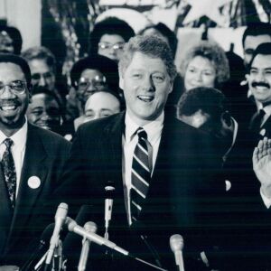 Arkansas Gov. Bill Clinton (right), shown with Ald. Bobby L. Rush (2nd) at the University of Illinois at Chicago, signs up Chicago political celebrities as delegates supporting his Democratic presidential bid. January 13, 1992.