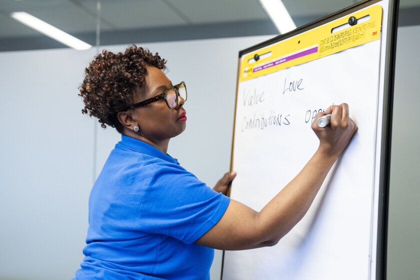 Crystal Odom-McKinney, national director of Easterseals’ Senior Community Service Employment Program, writes on a large notepad during a training for older adults.