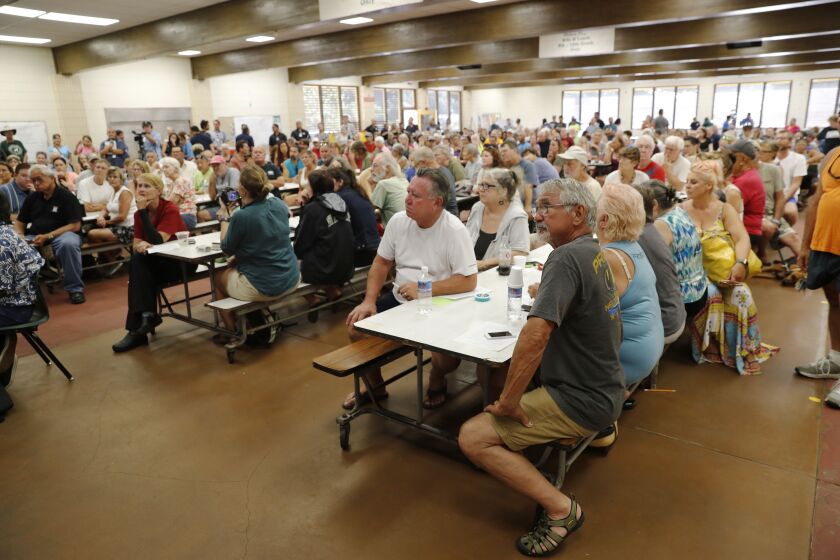 Residents from the lava affected areas attend a community meeting at Pahoa High School, Friday, May 4, 2018, in Pahoa, Hawaii. Community leaders, scientists, and local authorities answers questions about the lava eruption and evacuation plans. (AP Photo/M