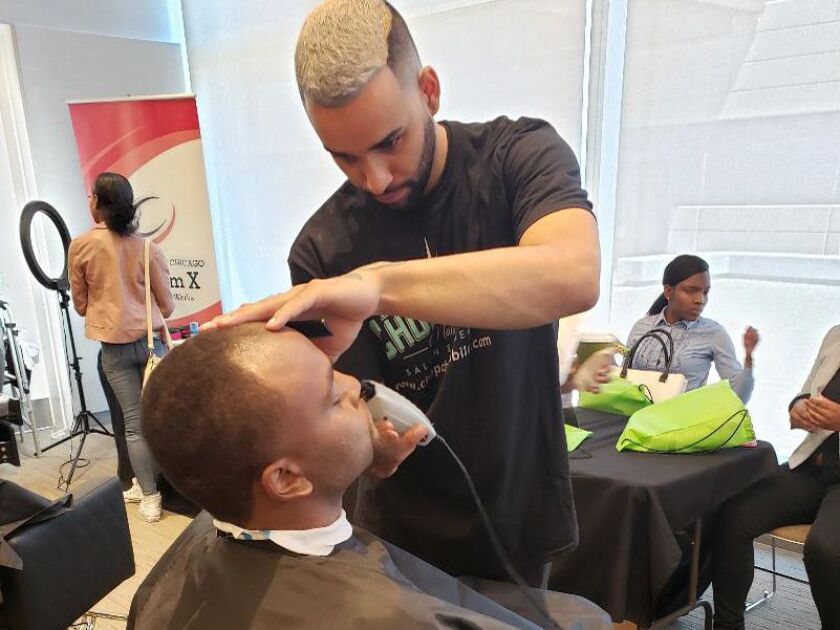 A jobseeker gets a free haircut at LeadersUp’s job fair.