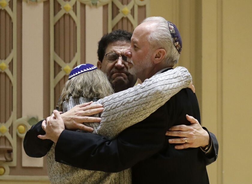 Rabbi Jeffrey Myers, right, of Tree of Life hugs Rabbi Cheryl Klein, left, of Dor Hadash Congregation and Rabbi Jonathan Perlman in the aftermath of the deadly shooting. | AP