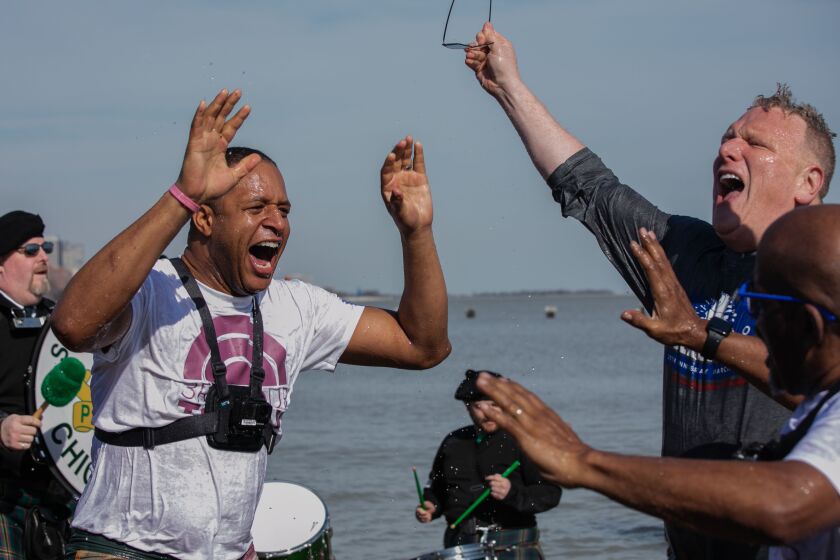 “Today” show anchor Craig Melvin, Jon Harris, and “Today” show weather forecaster Al Roker give each other high fives after taking a dip in Lake Michigan during the 20th annual Chicago Polar Plunge at North Avenue Beach, Sunday morning, March 1, 2020.