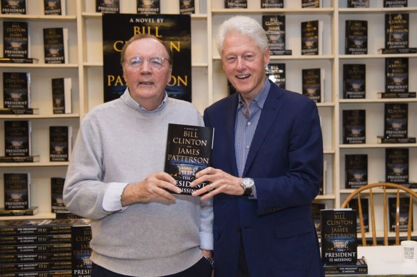 In this June 28, 2018 file photo, President Bill Clinton and author James Patterson appear at a book signing for “The President is Missing” in Huntington, N.Y. The million-selling collaboration between Clinton and James Patterson was the novel of the summ