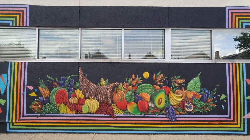 The cornucopia was painted by Damien Perdue, a 44-year-old Logan Square artist. The lines around those images are the work of James Jankowiak, a 51-year-old artist from the Southwest Side who specializes in abstract art.