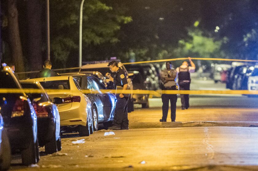 Chicago Police officers investigate the scene where a 12-year-old girl was killed and a 36-year-old man man who was wounded Thursday night in the 5200 block of West Wilcox in Chicago. | Tyler LaRiviere/Sun-Times