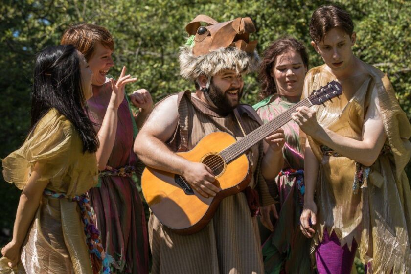 Jack Morsovillo (playing guitar) is surrounded by Kat Zheng, Hannah Mary Simpson, Elizabeth Quilter and Travis Shanahan in “A Midsummer Night’s Dream.”
