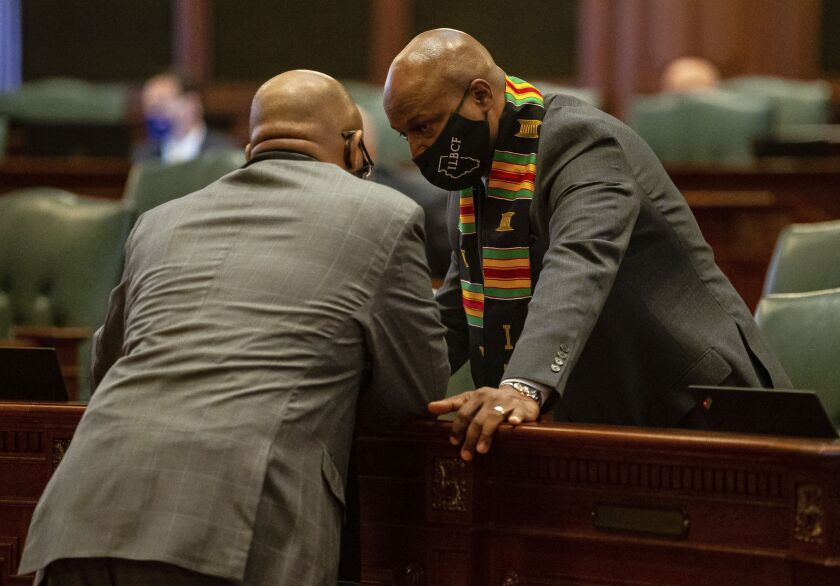 Illinois Speaker of the House Emanuel “Chris” Welch, D-Hillside, talks with Illinois State Rep. Will Davis, D-Homewood, during session on the floor of the Illinois House.