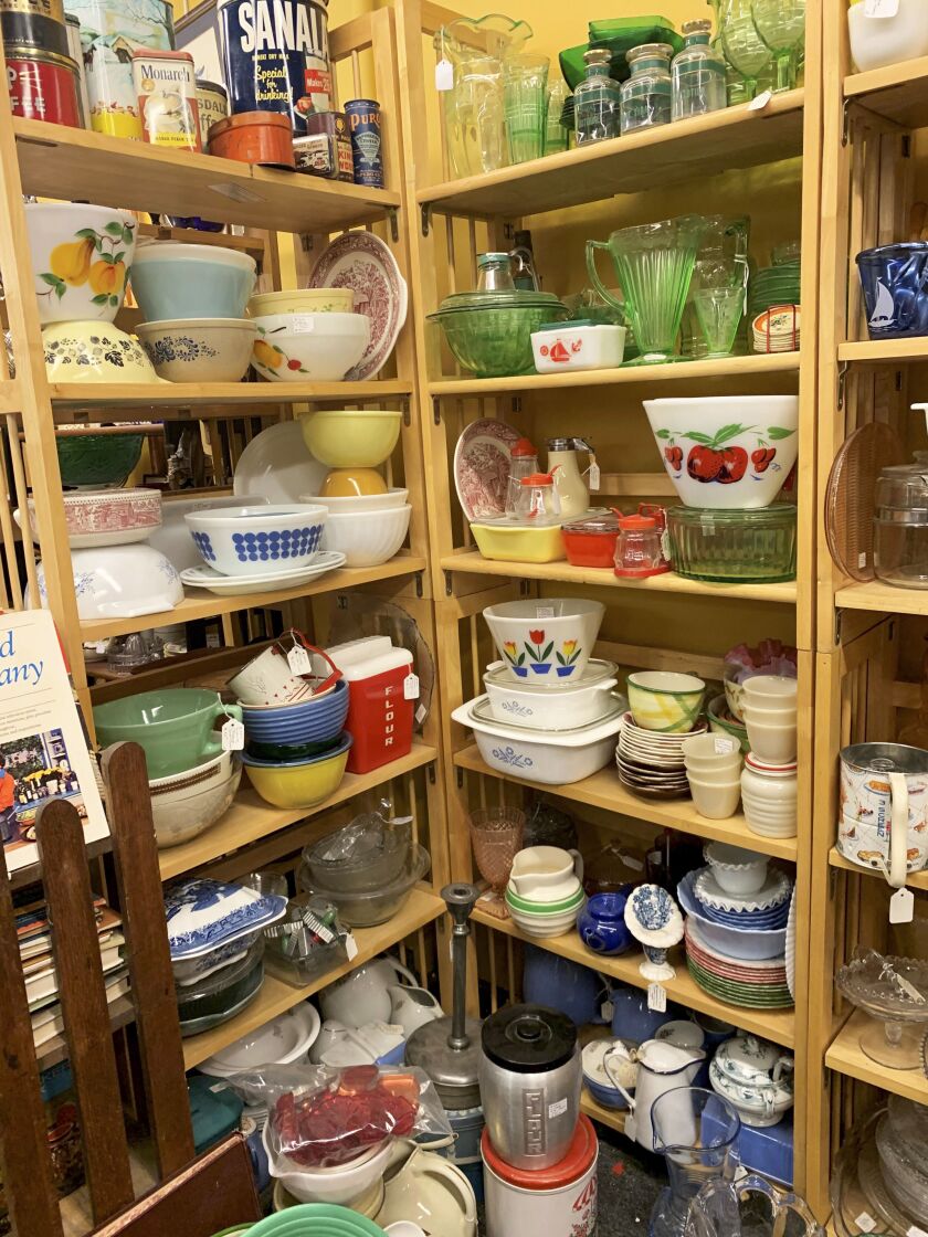 This image provided by Tracee Herbaugh exhibits some of the vintage kitchenware available at a Waltham, Massachusetts antique shop. Television and social media have also generated interest. Series like “WandaVision,” “Firefly Lane,” “The Marvelous Mrs. Maisel” and “Mad Men” all highlight midcentury kitchens and kitchenware.