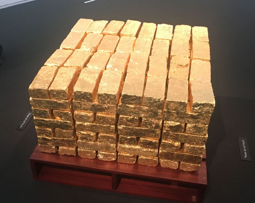 This stack of bricks, salvaged from demolished buildings, were painted gold by artist Amanda Williams to highlight the different ways in which bricks can have value — both as building materials and as a symbol of wealth. | Amanda Svachula/For the Sun-Time