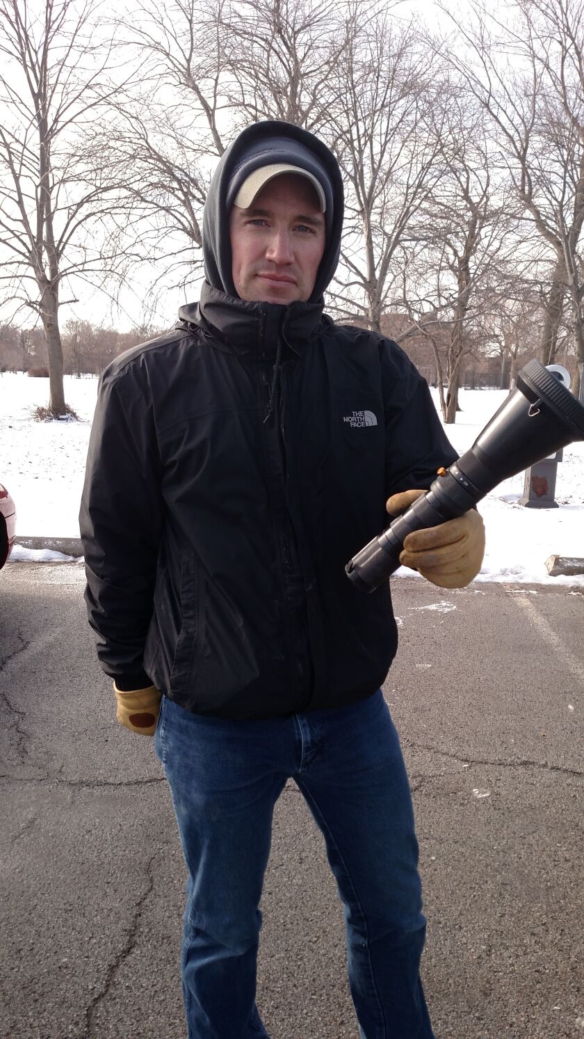 Brett Dorak holds “The Flashlight, ” the net launcher allowed for study by the Chicago Park District.<br>Credit: Dale Bowman