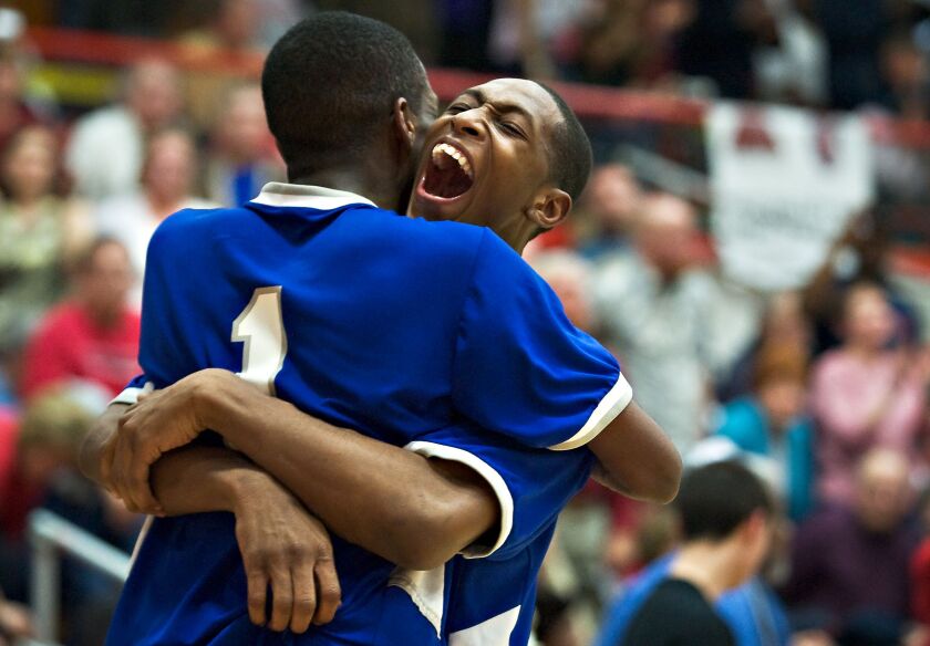 Proviso East’s Branden Jenkins, right, hugs teammate Paris Lee.