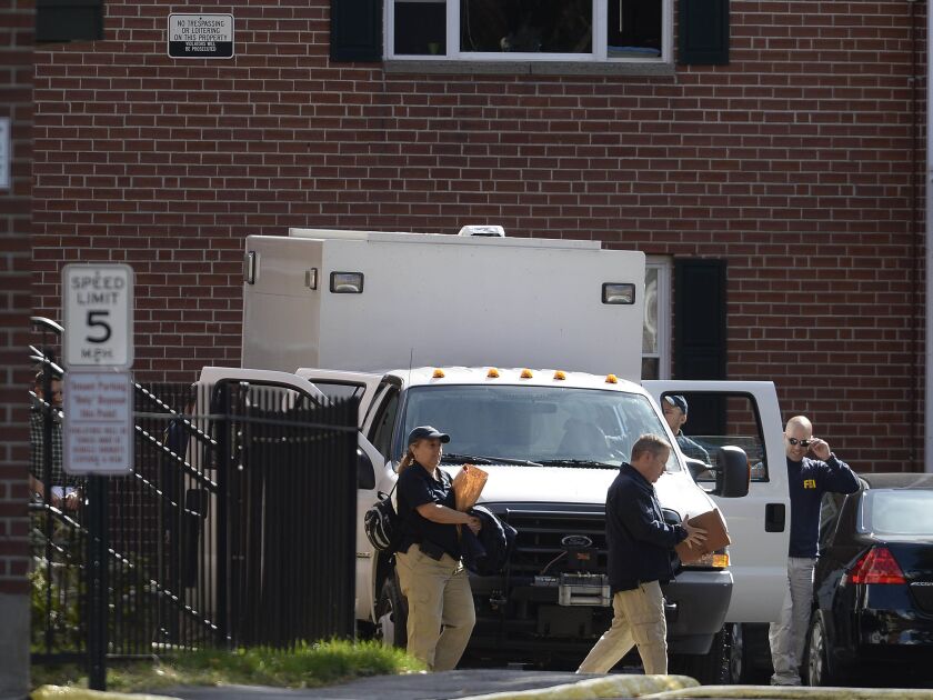 The FBI investigates a residence at Ritz Grande Apartments on Wednesday, Oct. 12, 2016, in Hartford, Connecticut. Local, state and federal authorities were investigating an apartment in connection with the plane crash, Deputy Police Chief Brian Foley said