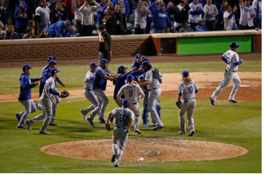 <em>Dodgers rush to the middle of the diamond to celebrate.</em>